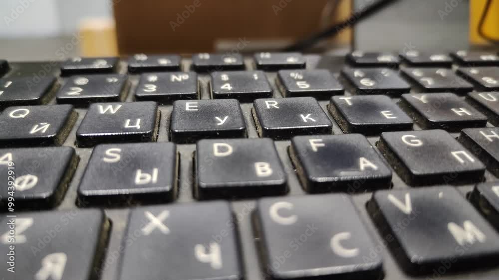 Old computer keyboard with dirt, dust and crumbs. High angle close up of the dust and fingerprints on the black keys of laptop computer in craftsmans workshop. Slow motion, side view Old computer keyboard with dirt, dust and crumbs. High angle close up of the dust and fingerprints on the black keys of laptop computer in craftsmans workshop. Slow motion, side view