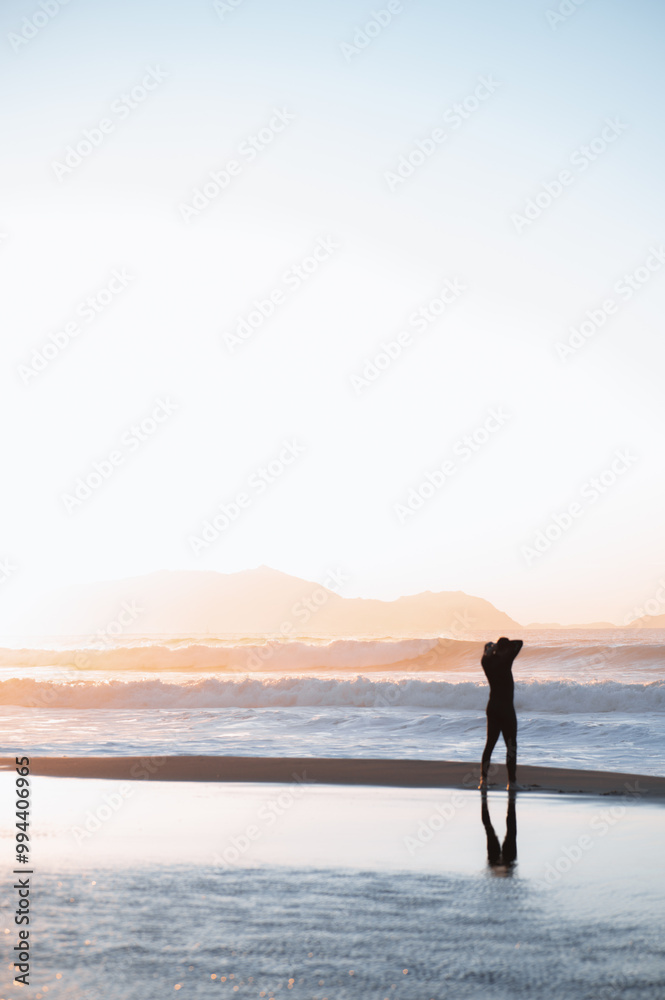 Fototapeta premium surfer watching the sea preparing the next wave at sunset