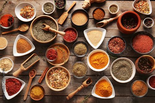 Fototapeta Naklejka Na Ścianę i Meble -  Many bowls with different spices on wooden background
