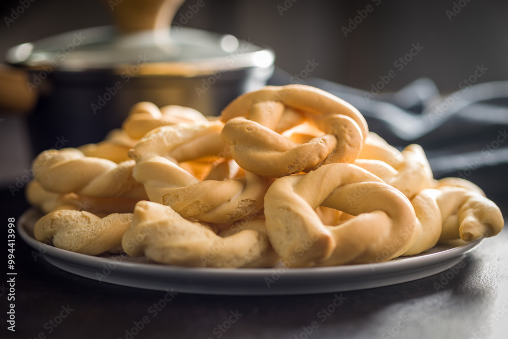 Ciambelle di pane. Crispy italian salted donuts on plate on black table. Ciambelle di pane. Crispy italian salted donuts on plate on black table.