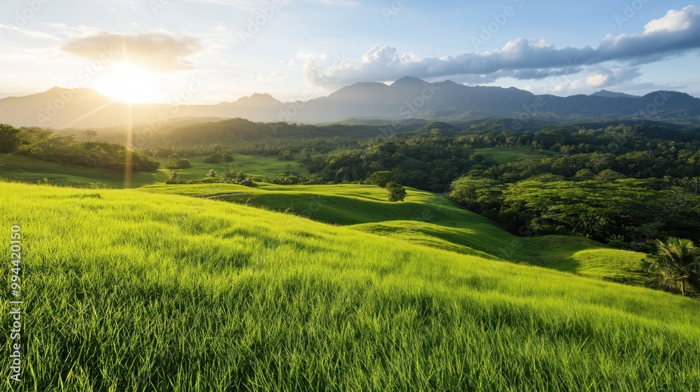 Golden sunlight breaks over rolling green hills, illuminating the vibrant landscape while majestic mountains rise in the distance, creating a peaceful natural setting Golden sunlight breaks over rolling green hills, illuminating the vibrant landscape while majestic mountains rise in the distance, creating a peaceful natural setting