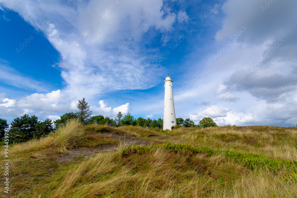 The white lighthouse under blue sky, The south tower (Zuidertoren) or water tower, Schiermonnikoog is a municipality and national park in the Northern Netherlands and one of the West Frisian Islands. The white lighthouse under blue sky, The south tower (Zuidertoren) or water tower, Schiermonnikoog is a municipality and national park in the Northern Netherlands and one of the West Frisian Islands.