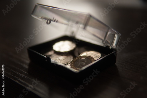 Jamaican and Canadian coins in a small safe photo