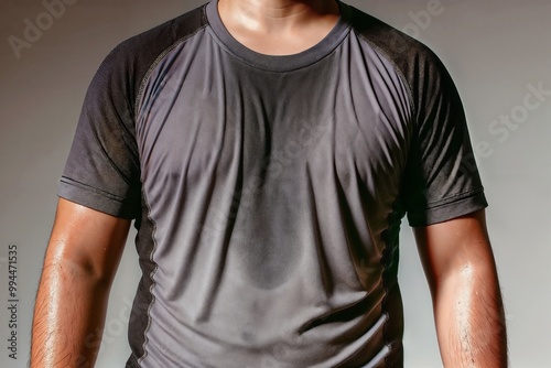 Close-up of man in sweaty shirt after intense workout at the gym
