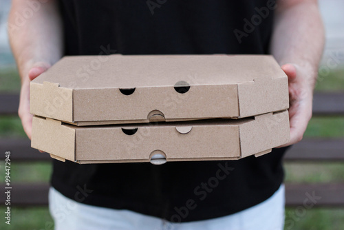 a person holding pizza boxes