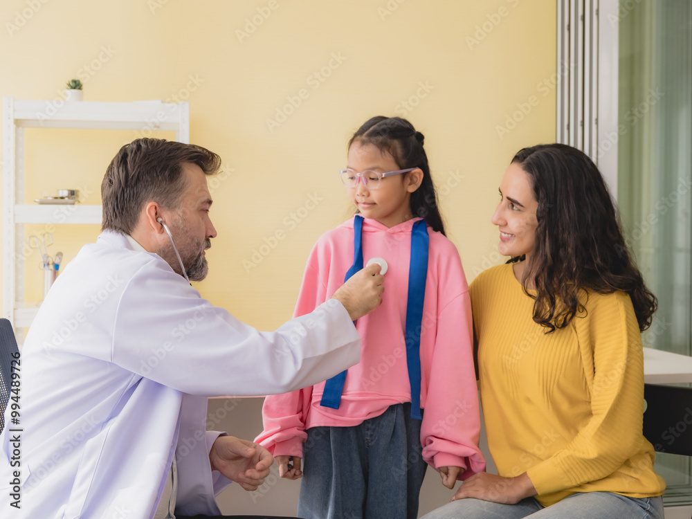 Obraz premium Doctor man care caucasian sitting use stethoscope check girl sick illness daughter who came to hospital with mother woman three people with talk helping support give advice inside treatment room