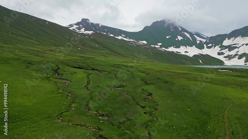 Dudipatsar Lake, a pristine blue alpine lake nestled among the snow-capped mountains of Pakistan's Kaghan Valley.