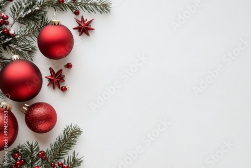 Festive red ornaments and pine branches for a joyful holiday celebration back...