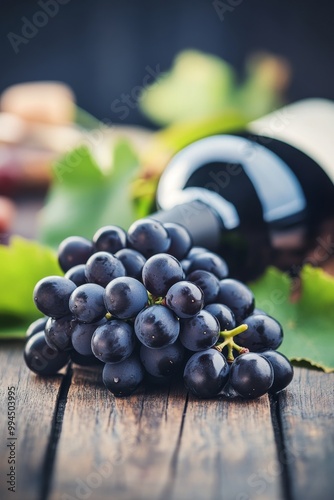 Freshly harvested grapes and red wine on rustic wooden table ready for tastin...