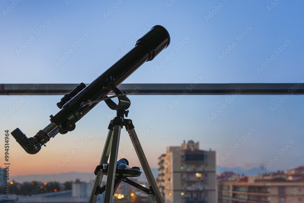 Telescope Facing Twilight Sky Over the City Telescope Facing Twilight Sky Over the City
