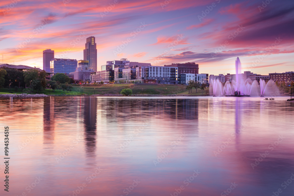 Omaha, Nebraska, USA. Cityscape image of downtown Omaha, Nebraska with reflection of the skyline at beautiful autumn sunset.