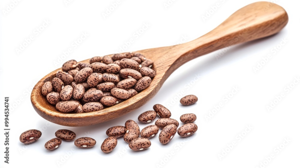 Obraz premium Whole pinto beans with a brown spoon