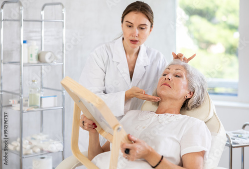 Doctor and patient in consultation before treatment or cosmetic surgery. Beauty industry concept.
