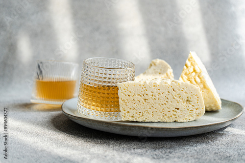 Traditional Georgian Sulguni cheese and Amber wine on a plate photo