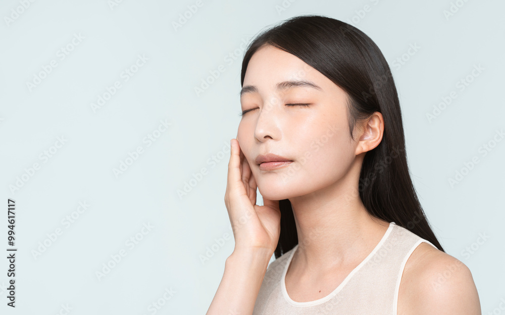 Skin care. Woman with beauty face touching healthy facial skin portrait. Asian woman.
Skin care. Woman with beauty face touching healthy facial skin portrait. Asian woman.