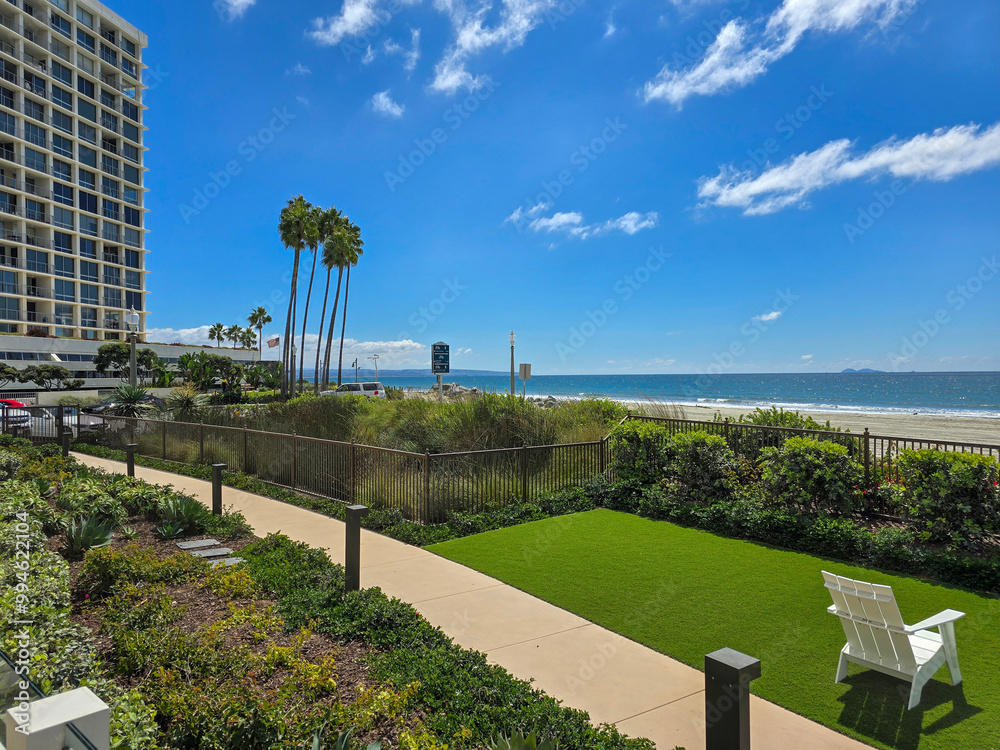 Fototapeta premium a gorgeous landscape at Coronado Beach with blue ocean water, white sand, blue sky and clouds at Hotel del Coronado in Coronado California USA