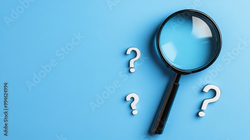 Magnifying glass and question mark signs on a blue background Representing the search for information solutions or answers ideal for inquiry or researchrelated themes photo