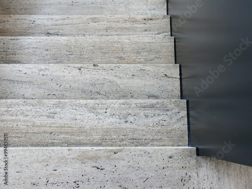 Top view of stone stairs with black railing photo