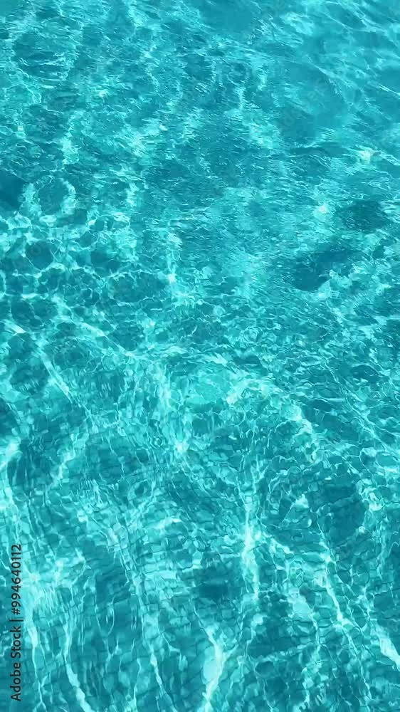 Clear Turquoise Water Surface, Stunning Vertical Video of Crystal clear pool surface