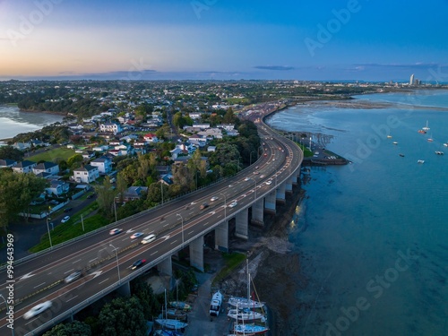 Traffic crossing the Auckland Harbour Bridge at sunset, Auckland, Auckland, New Zealand. photo