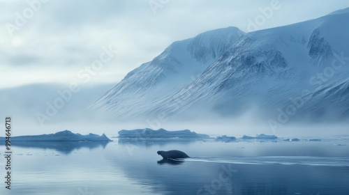 A lone seal swims in a frozen Arctic landscape, with snow-covered mountains in the background and icebergs floating in the water.