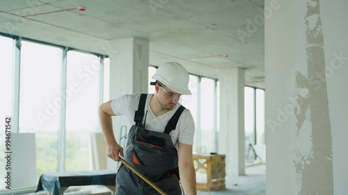 Wallpaper Mural Builder Applying Wall Finish with Roller at Construction Site Torontodigital.ca