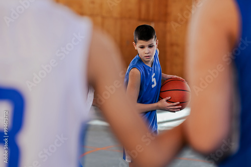 Focused kid holding a basketball photo