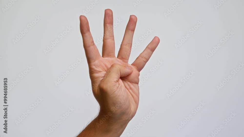 Man showing four fingers with hand against plain white background signifying the number four Man showing four fingers with hand against plain white background signifying the number four