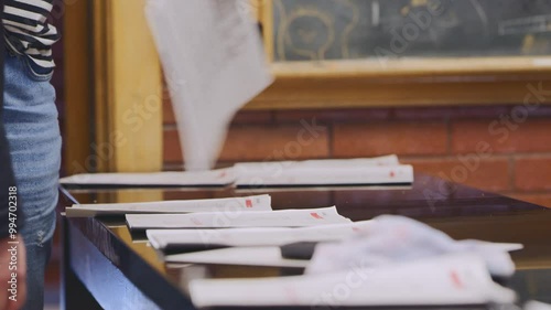 Students gather assignments from classroom table during study session