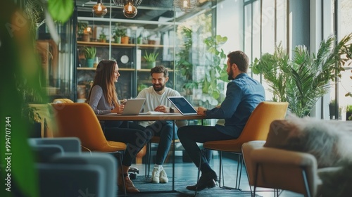 Meeting of Three Colleagues in a Modern Office