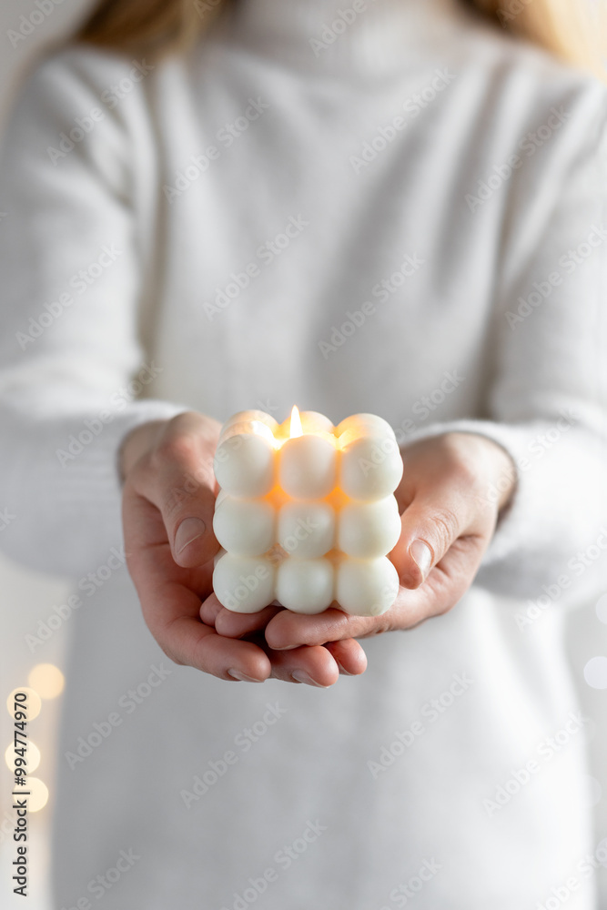Woman holding burning candle with wooden wick, closeup Woman holding burning candle with wooden wick, closeup