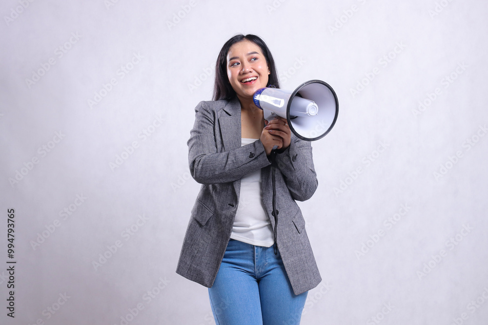 beautiful woman shouting formal cheerful candid both hands holding loudspeaker megaphone forward wearing grey suit isolated on white background. fashion concept, lifestyle, advertising, sale, company beautiful woman shouting formal cheerful candid both hands holding loudspeaker megaphone forward wearing grey suit isolated on white background. fashion concept, lifestyle, advertising, sale, company
