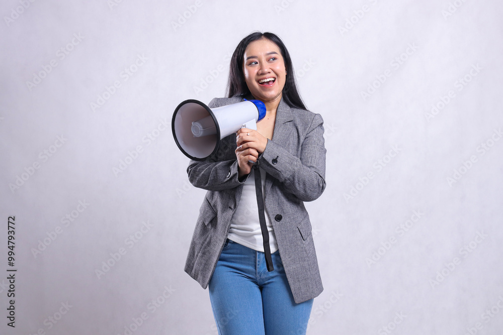 beautiful ladies shouting formal cheerful candid both hands holding loudspeaker megaphone right wearing grey suit isolated on white background. fashion concept, lifestyle, advertising, sale, company beautiful ladies shouting formal cheerful candid both hands holding loudspeaker megaphone right wearing grey suit isolated on white background. fashion concept, lifestyle, advertising, sale, company
