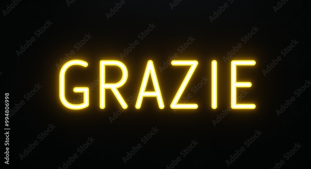 grazie word lettering with yellow glow on plain black dark background grazie word lettering with yellow glow on plain black dark background