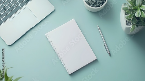 A birds-eye view of a clean workspace with just a notebook and a pen on the desk, no clutter in sight, highlighting its functional simplicity. photo