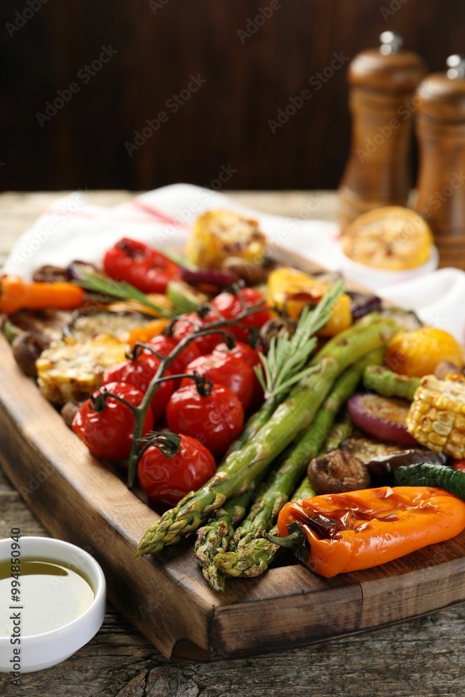 Delicious grilled vegetables with spices on wooden table, closeup Delicious grilled vegetables with spices on wooden table, closeup