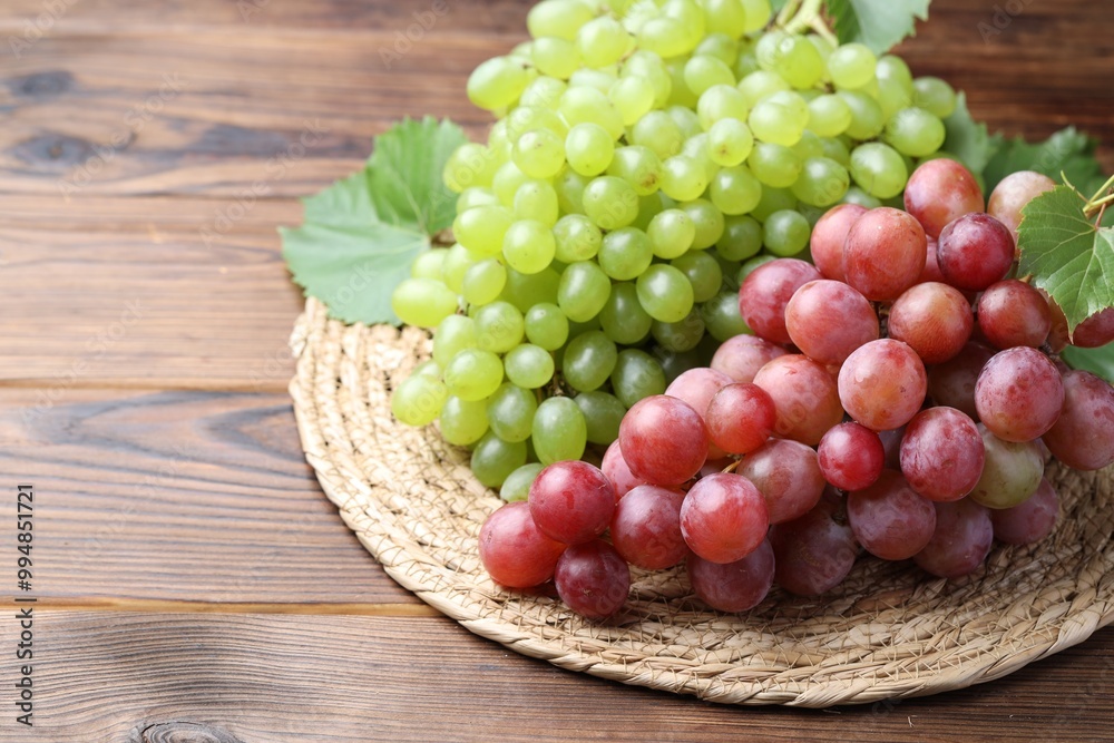 Delicious fresh ripe grapes on wooden table Delicious fresh ripe grapes on wooden table