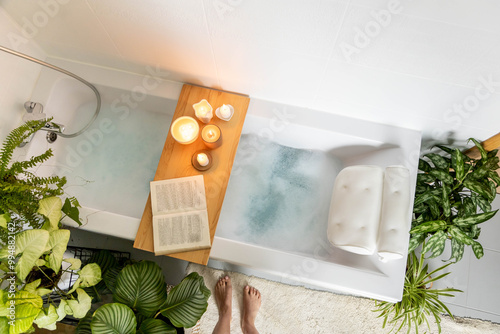 A woman stands in front of a bathtub filled with white foam. The concept of relaxation, self-love