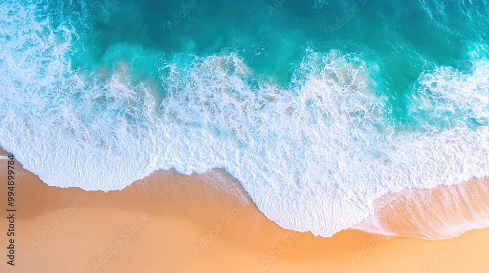 Fototapeta premium Aerial view of turquoise ocean waves hitting the golden sand on beach