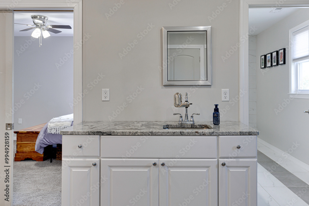 Fototapeta premium Bathroom Sink Area With Granite Counter, White Cabinets