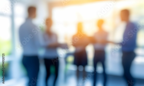 Blurred silhouettes of business people in a modern office.