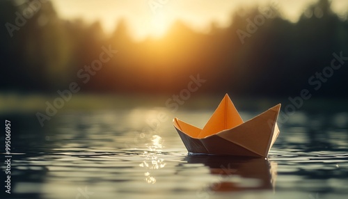 A serene scene of a paper boat gently floating on a calm water surface, illuminated by a warm sunset glow.