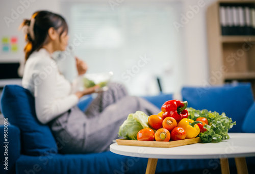 Businesswoman enjoying a healthy salad on a office couch, promoting work-life balance and wellness with fresh veggies