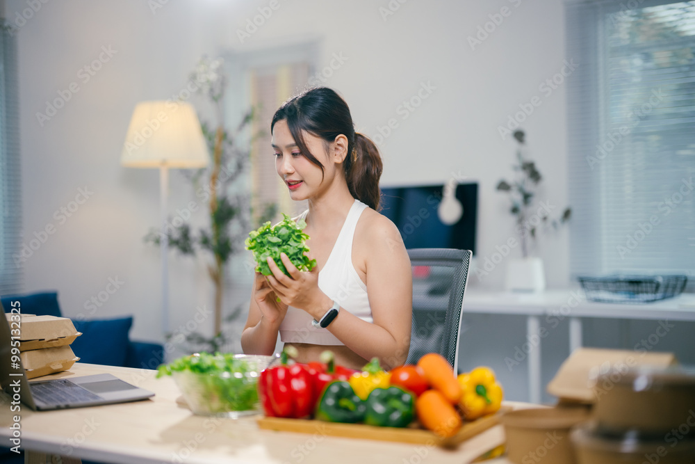 Nutritionist is showing fresh lettuce during an online video call consultation while being surrounded by fresh vegetables Nutritionist is showing fresh lettuce during an online video call consultation while being surrounded by fresh vegetables
