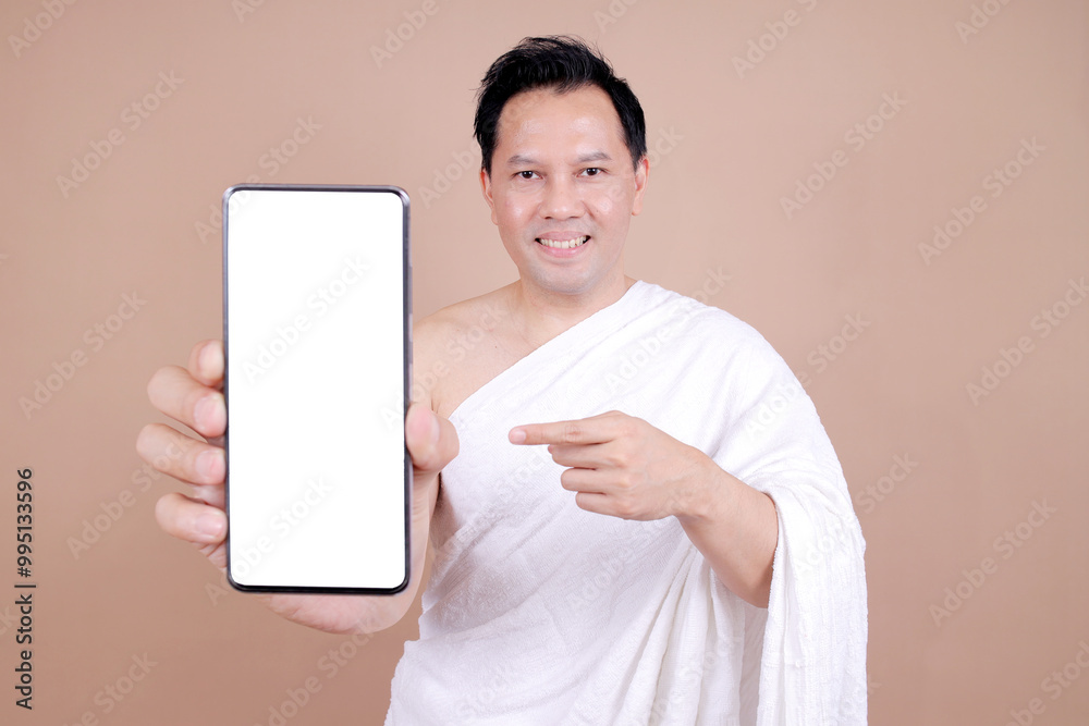 Asian Muslim Man in White Ihram Pointing Phone Screen Asian Muslim Man in White Ihram Pointing Phone Screen