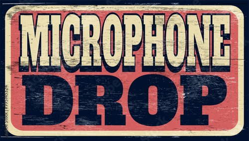 Aged and worn microphone drop sign on wood