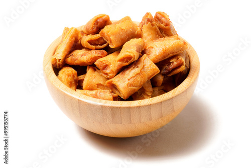 A bowl of Sumpia, Indonesian traditional mini spring rolls filled with shrimp floss. The crunchy outer wrapper is deep-fried to perfection. Photographed on a white background.