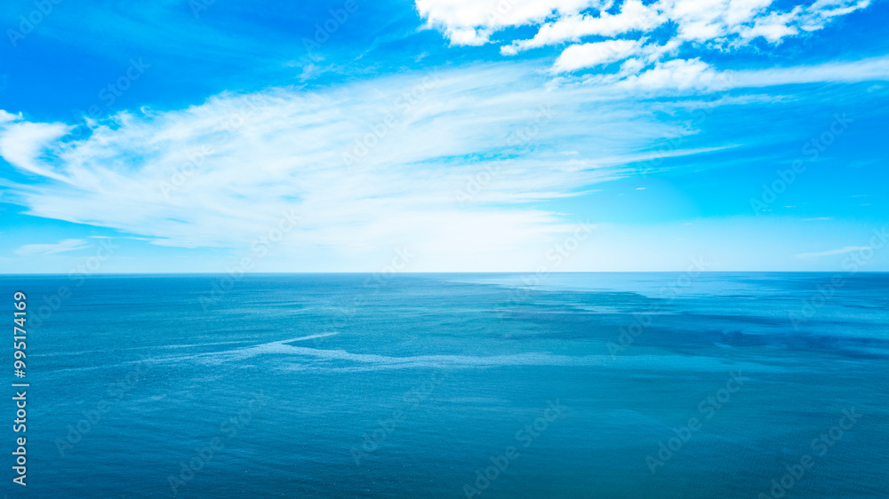 Obraz premium Nature of the beach and sea Summer with sunshine, sandy beaches, clear blue waters sparkling against the blue sky. On an island with good ecology and environment Background for summer vacation concept