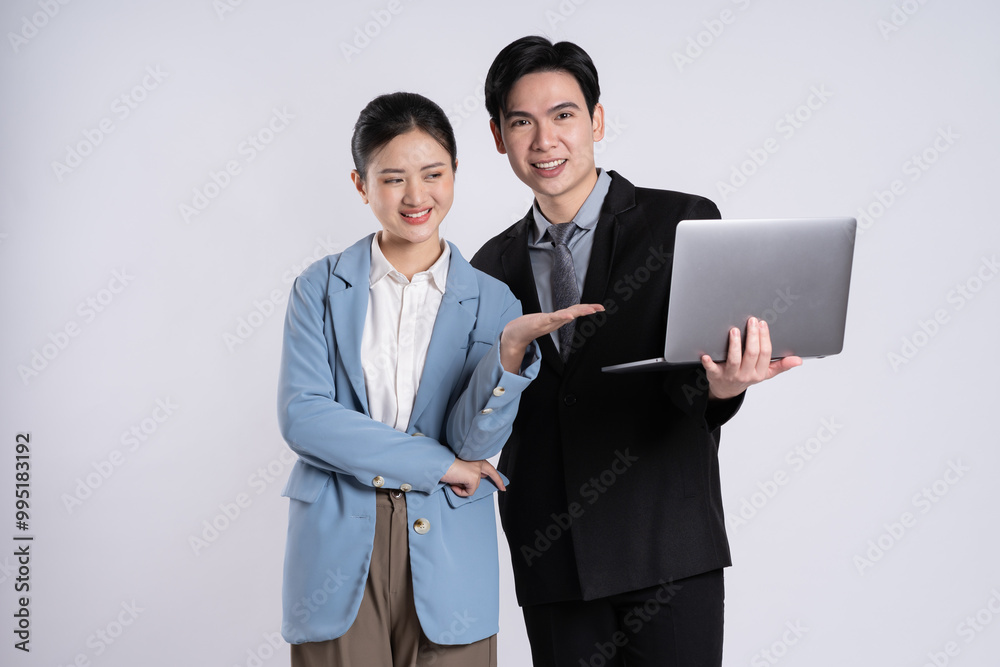 Image of an Asian business couple posing on a white background. Image of an Asian business couple posing on a white background.