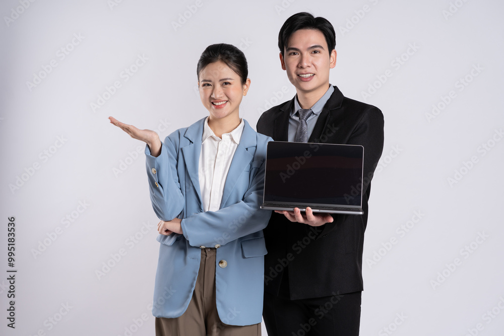 Image of an Asian business couple posing on a white background. Image of an Asian business couple posing on a white background.